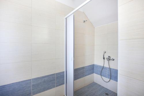 a shower with a glass door in a bathroom at Psaromatis in Elafonisos
