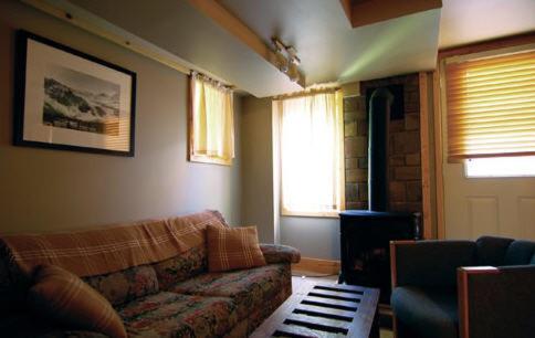 a living room with a couch and a window at Charlie's Guesthouse in Field