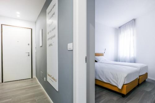 a bedroom with a bed and a mirror at Bertamini Apartments in Nago-Torbole