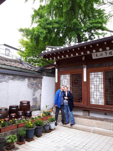 two men standing in front of a building at Lydia Craft Guesthouse in Seoul