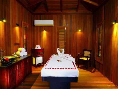 a room with a bed with two swans on it at Niraamaya Retreats Cardamom Club in Thekkady