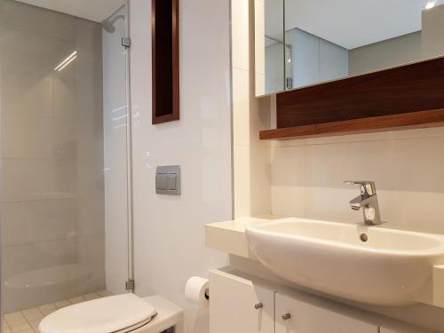 a bathroom with a sink and a toilet at Zimbali Suites 109 in Ballito