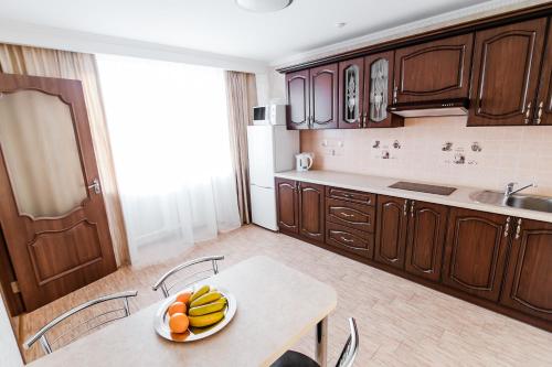 a white table topped with a banana peel and a bowl of fruit at Hotel Ukraine in Chernihiv