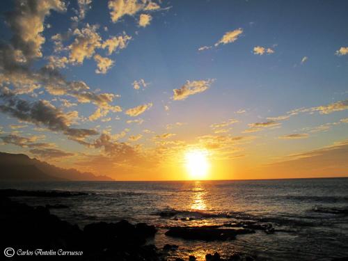 
a sunset view of the ocean with the sun setting at Seaside Villa - Agaete in Agaete
