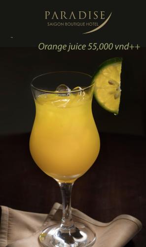 a glass of orange juice with a slice of lime at Paradise Saigon Boutique Hotel & Spa in Ho Chi Minh City