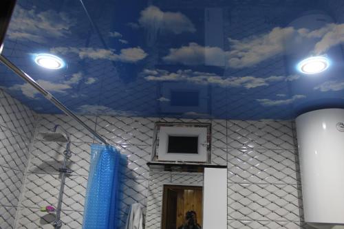 a room with a blue ceiling with clouds on the ceiling at Luka House in Akhaldaba
