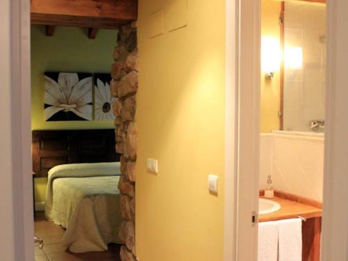 a bedroom with a bed and a bathroom with a sink at Casa Rural Ogoño Mendi in Elanchove