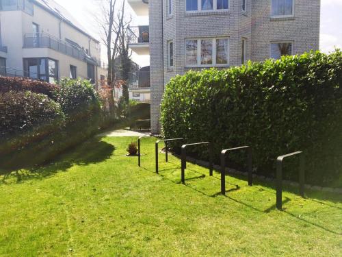a row of poles in the grass in front of a building at Ankerplatz Timmendorfer Strand in Timmendorfer Strand