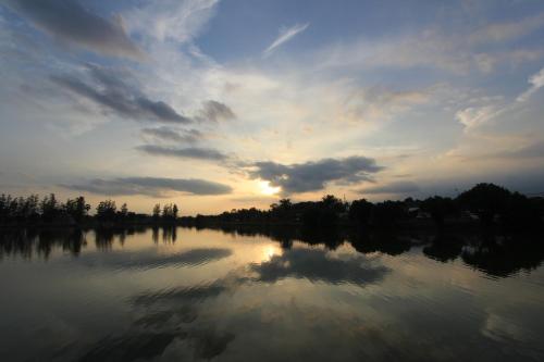 a large body of water with a cloudy sky at โรงแรมนางรอง in Nang Rong
