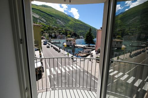 a balcony with a view of a street and a mountain at Bertamini Apartments in Nago-Torbole
