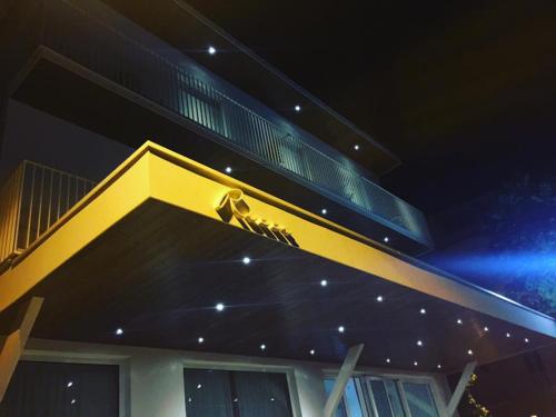 a yellow building with a balcony on top of it at Hotel Ricci in Rimini