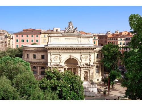 a large building with a statue on top of it at Hotel Kennedy in Rome