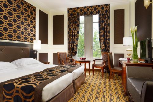 a hotel room with a bed and a desk at Grand Visconti Palace in Milan