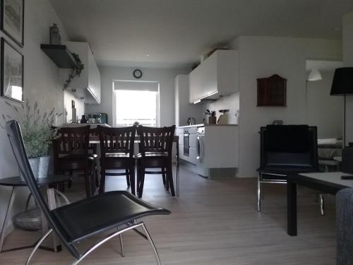 a kitchen and dining room with a table and chairs at Hals Hotel ferielejlighed in Hals