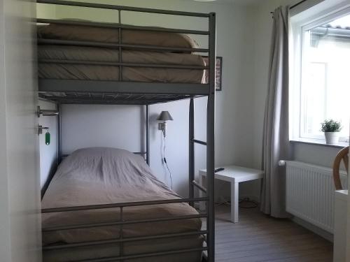 a bedroom with two bunk beds and a table at Hals Hotel ferielejlighed in Hals