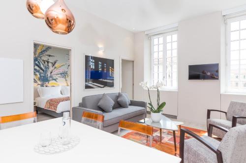a living room with a couch and a table at Palais Saleya Boutique Hôtel in Nice