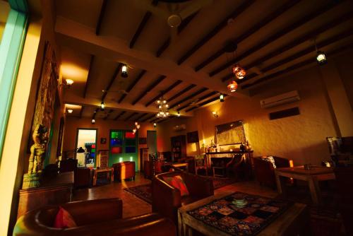 a living room with couches and a table and chairs at WelcomHeritage Ranjitvilas in Amritsar