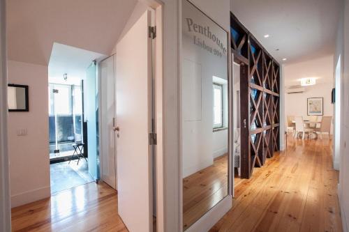 a hallway with a glass door leading to a dining room at Penthouse Lisboa 204 in Lisbon