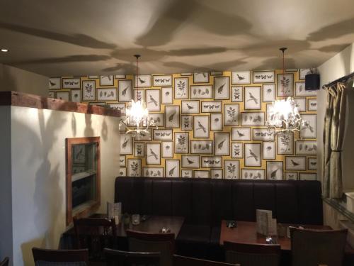 a dining room with a wall of pictures on the wall at Narrowboat at Weedon in Weedon Bec