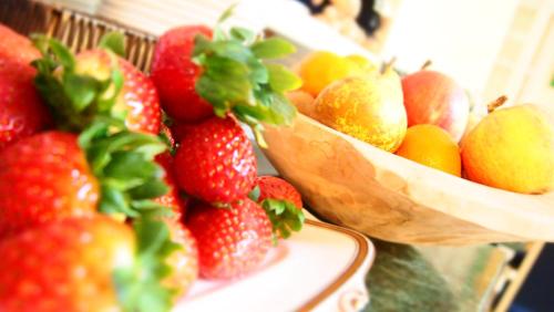 a bunch of strawberries and other fruit on a table at Privat Hotel Liberty Sitges in Sitges