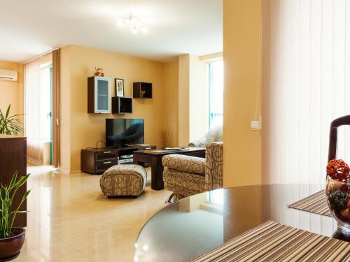 a living room filled with furniture and a tv at Bright House in Plovdiv