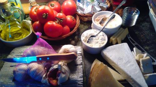 a table with tomatoes and other foods on it at Privat Hotel Liberty Sitges in Sitges