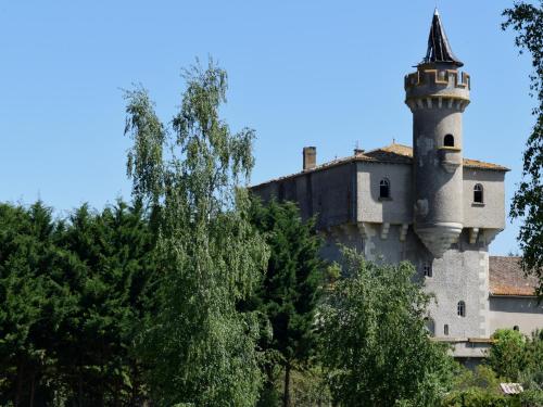 an old castle with a tower on top of trees at Fasthôtel - Saint Emilion Est in Montcaret