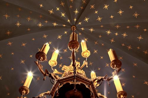 a chandelier hanging from a ceiling with stars at Due Torri Hotel in Verona