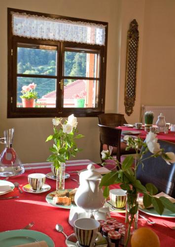 Una mesa con un mantel rojo y una ventana. en Ilaeira Mountain Resort, en Tóriza