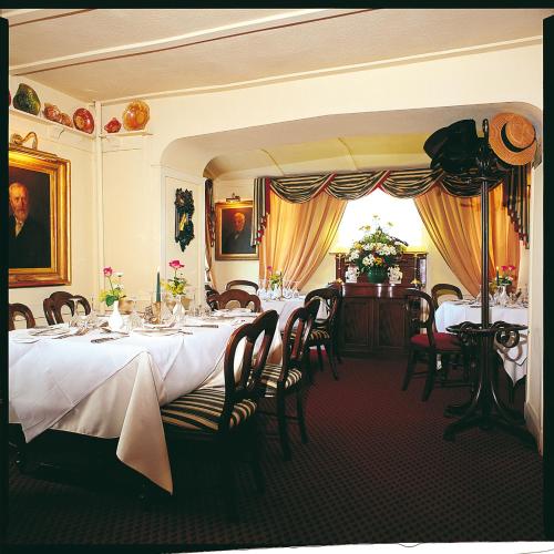 a dining room with a long table with white table cloth at The Groes Inn in Conwy