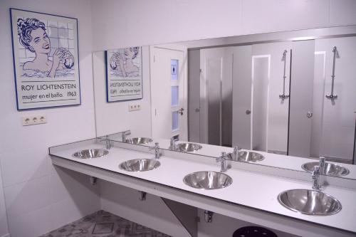a bathroom with three sinks and a large mirror at A Conserveira in Redondela