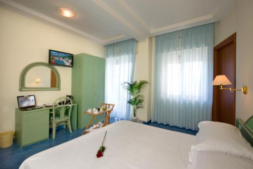 a hotel room with a bed and a desk at Hotel Pensione Reale in Maiori