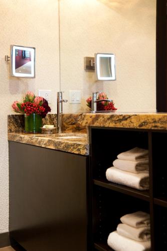 a bathroom with a sink and a counter with towels at Golden Gate Casino Hotel in Las Vegas