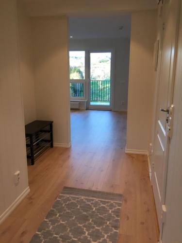 an empty living room with a door and a rug at Alver Hotel in Alversund