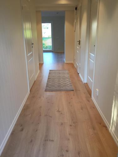 an empty hallway of a home with a hard wood floor at Alver Hotel in Alversund