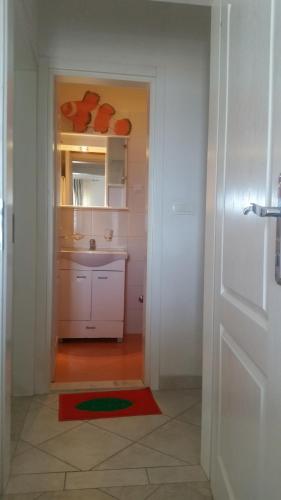 a bathroom with a sink and a white door at Apartments Miljevic in Herceg-Novi