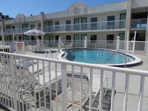 a view of the pool from the balcony of a hotel at Budget Inn in Cocoa