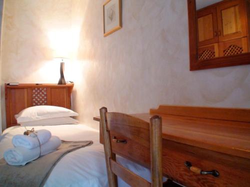 a bedroom with a bed and a dresser with towels on it at Polokwane Place in Polokwane