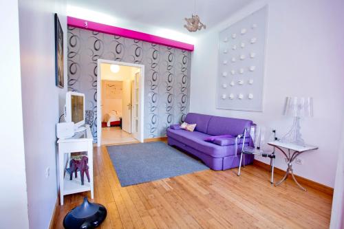 a living room with a purple couch in a room at Rooms Zagreb 17 in Zagreb
