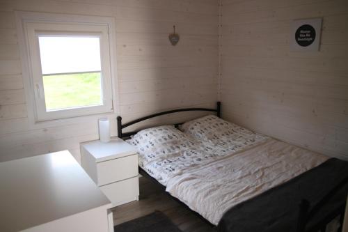 niewielka sypialnia z łóżkiem i oknem w obiekcie Przystanek Wakacje w mieście Mikołajki