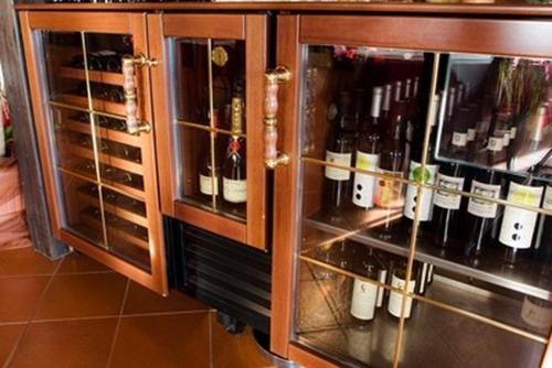 a cabinet filled with lots of bottles of wine at Hotel Makin in Novigrad Istria