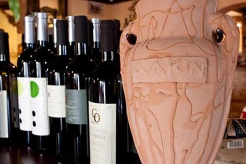 a vase sitting next to a bunch of wine bottles at Hotel Makin in Novigrad Istria