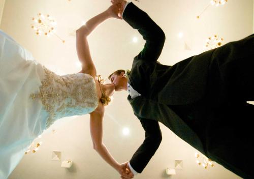 a bride and groom are dancing in a bedroom at Clanwilliam Hotel in Clanwilliam