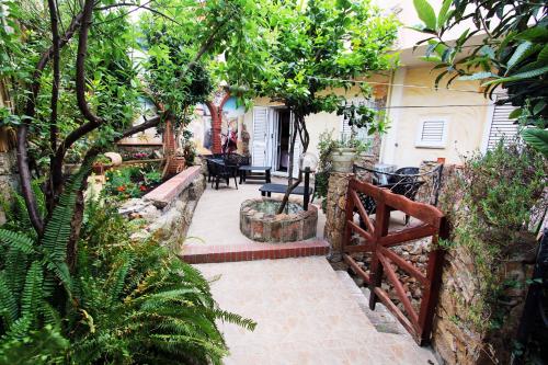 a patio with a fence and a table and chairs at B&B Sa Bèrtula in La Maddalena
