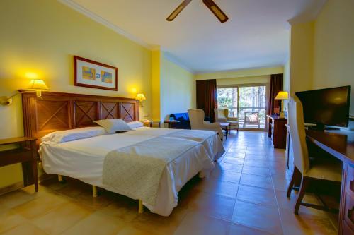 a hotel room with a bed and a television at SBH Costa Calma Palace Thalasso & Spa in Costa Calma