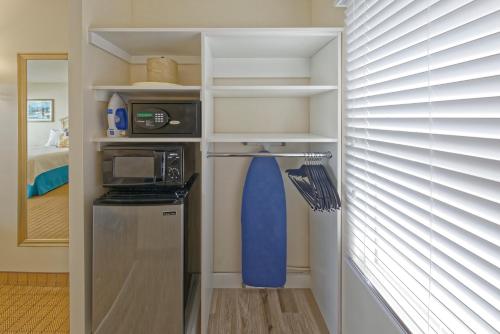 a small kitchen with a refrigerator and a microwave at Dunes Court in Ocean City