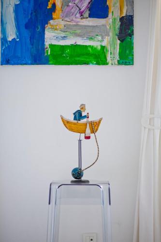 a painting and a toy on top of a suitcase at Rooms Zagreb 17 in Zagreb