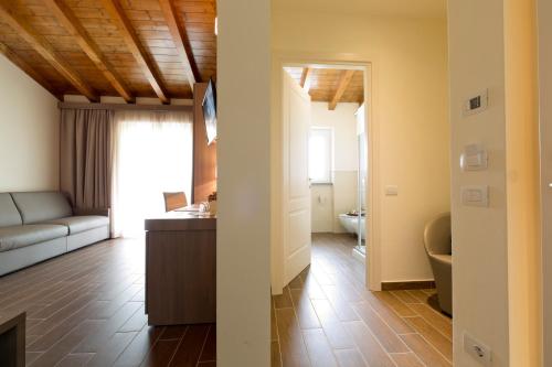 a living room with a couch and a table at Villa Carolina Resort in Castelletto d'Orba