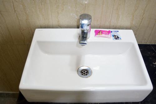 a white sink with a faucet in a bathroom at Trinity Corporate Udyog Vihar in Gurgaon