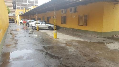 a parking lot with cars parked next to a building at Hotel Suma Huasi in San Fernando del Valle de Catamarca